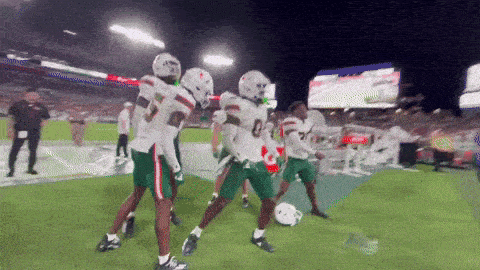 a group of football players are celebrating a touchdown