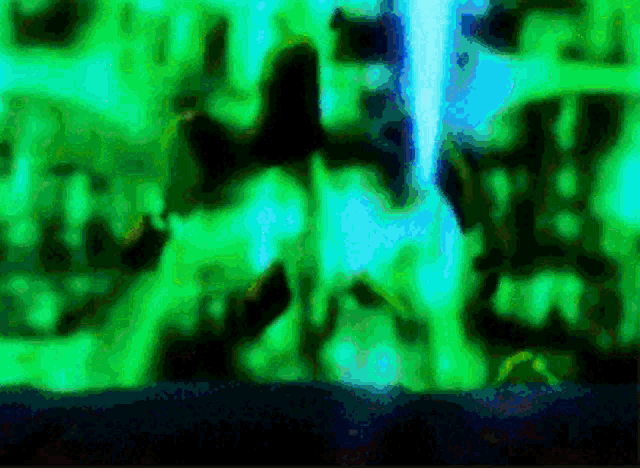 a green and blue background with a person standing in the middle