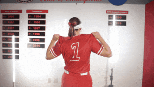 a woman in a red jersey with the number 1 on the back