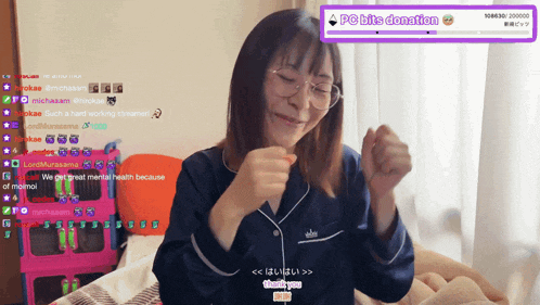 a woman sitting on a bed in front of a screen that says ' pc bits donation ' on it