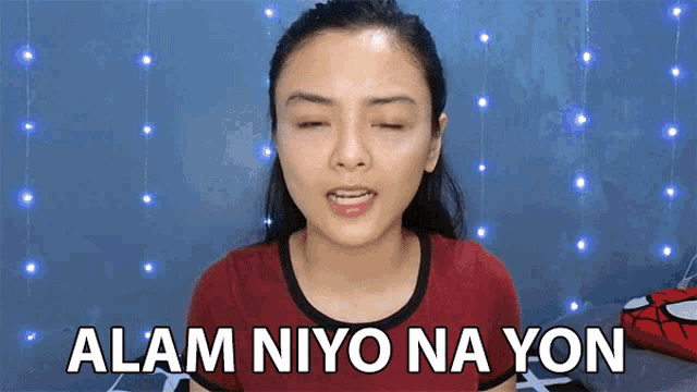 a woman with her eyes closed and the words alam niyo na yon written on her face