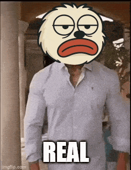 a man wearing a shirt with a cartoon character on his head and the words real on the bottom