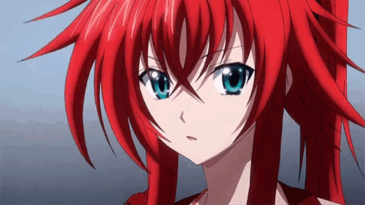 a close up of a girl with red hair and blue eyes