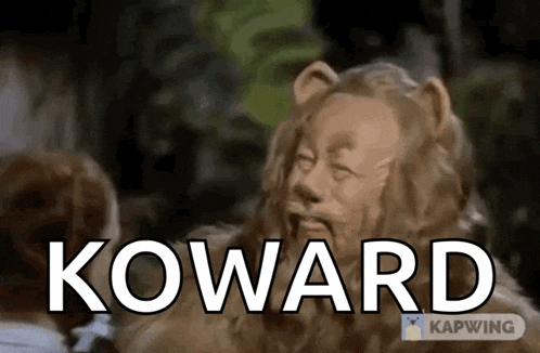 a wizard of oz lion with the word koward in front of him