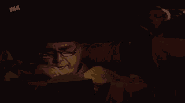 a man reading a book with the word viva on the bottom left