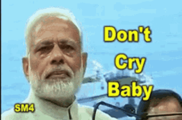 a man with a beard is crying with the words `` do n't cry baby '' written above him .
