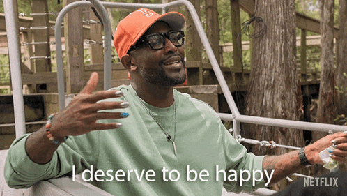 a man wearing a hat and glasses says i deserve to be happy