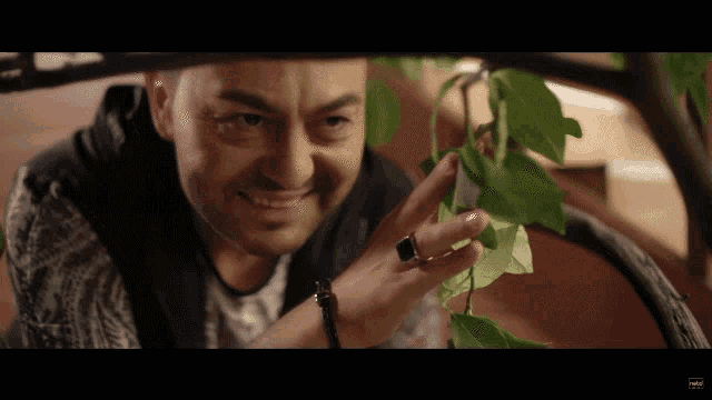 a man with a ring on his finger looks at something