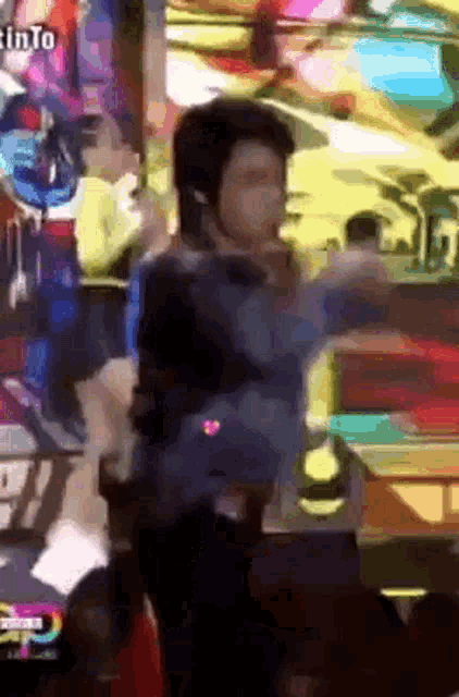a man is standing in front of a crowd with a sign that says ' infinite ' on it