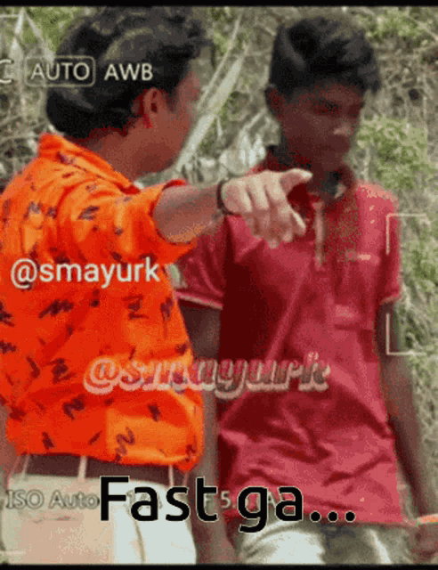two men are standing next to each other and one is pointing at the other