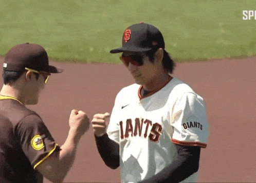 a giants baseball player shakes hands with a padres player