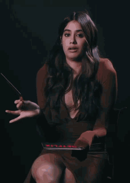a woman in a red dress is holding a netflix book