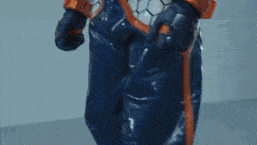 a close up of a person wearing a superhero costume and gloves .