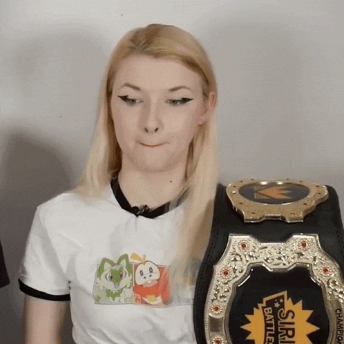 a woman in a white shirt is holding a championship belt that says ' sim battle ' on it
