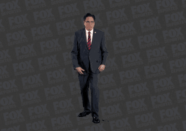 a man in a suit and tie is dancing in front of a fox logo