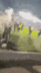 a blurry picture of a group of people walking down a road .