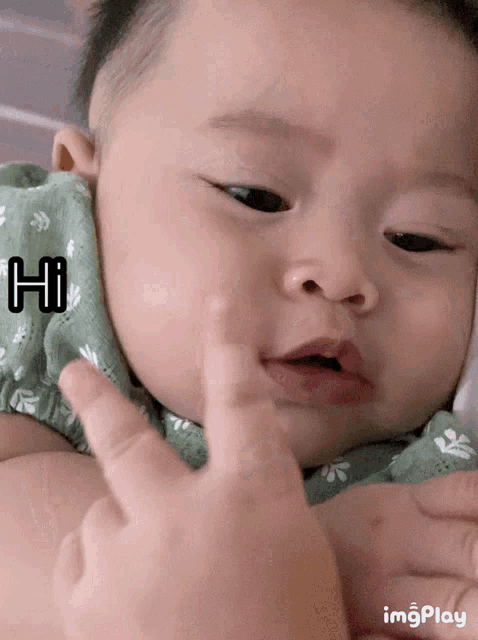 a baby 's face is shown with the word hi on the bottom right