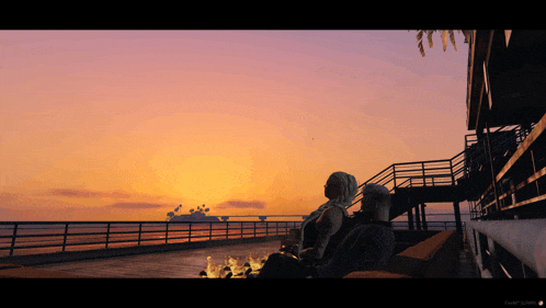 a man and a woman are sitting on a pier watching the sunset