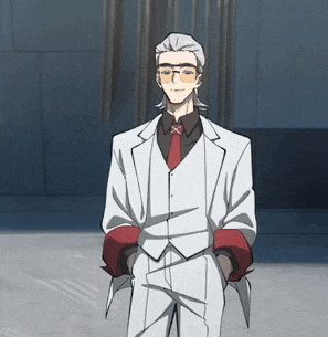 a man in a white suit with a red tie