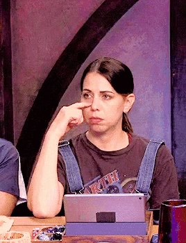 a woman is sitting at a table with a tablet and a t-shirt that says ruth