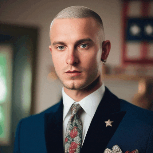 a man in a suit and tie with a star on his jacket