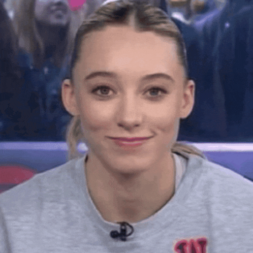 a woman wearing a gray sweatshirt with the word tnt on it