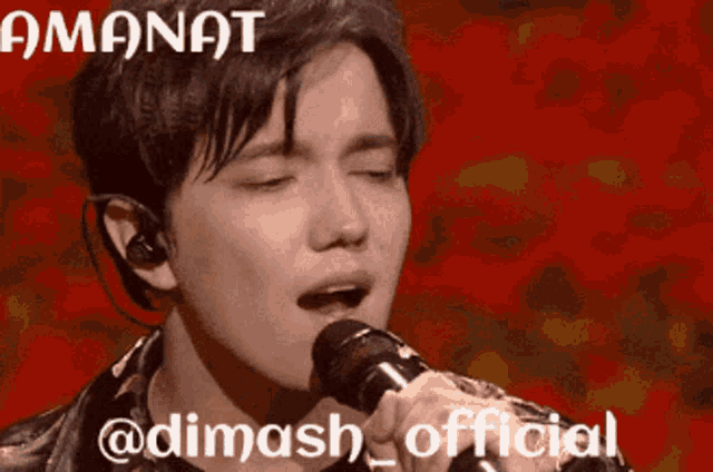 a man singing into a microphone with a red background that says ' amongt @dimash_official ' on it
