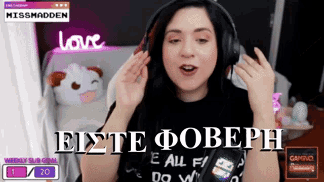 a woman wearing headphones and a shirt that says e all f