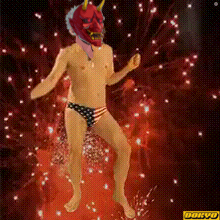 a man with a red mask on his head is dancing