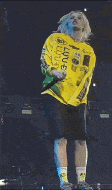 a person wearing a yellow shirt that says no gain on it