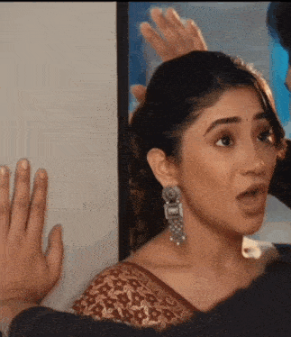 a woman wearing earrings is being touched by a man