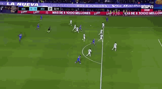a soccer game is being played in front of a large espn advertisement
