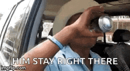 a man is sitting in a car drinking from a can and says `` him stay right there '' .