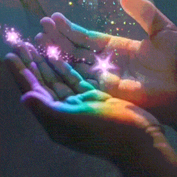 a close up of a person 's hands with a rainbow of colors and sparkles coming out of them .