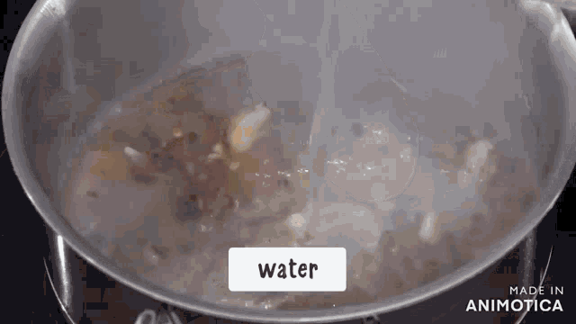 a pot of water is being poured into a pot of food