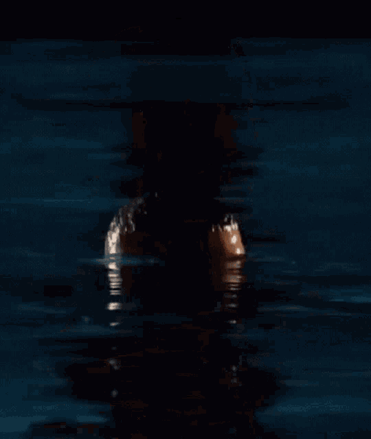 a man with a beard is standing in a pool of water .