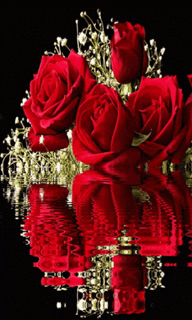 a bunch of red roses floating in the water