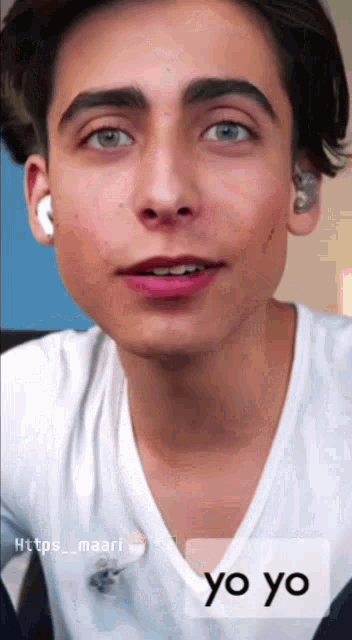 a close up of a young man 's face with the words yo yo written below him