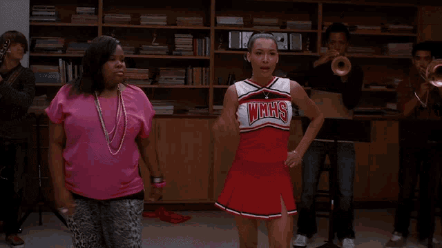 two cheerleaders wearing wmhs uniforms holding hands