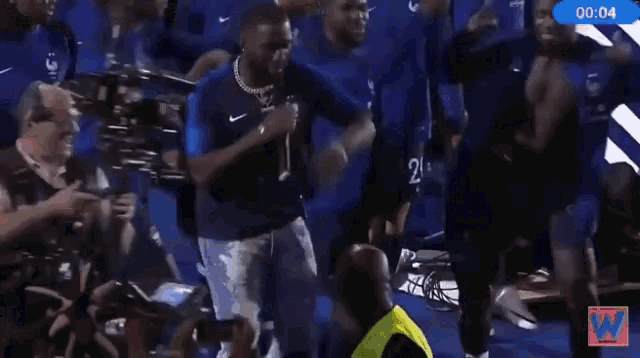 a group of soccer players are dancing in front of a sign that says brian on it
