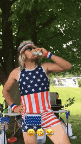 a man in an american flag outfit drinks a beer