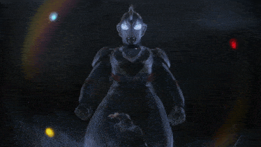 a man is standing next to a giant robot with a red z on his face
