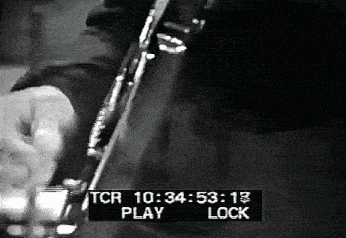 a black and white photo of a person playing a guitar with a tcr play and lock displayed