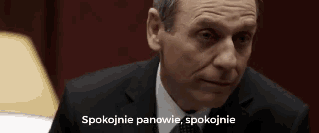 a man in a suit and tie is talking in polish