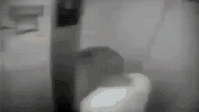 a black and white photo of a person standing in a room