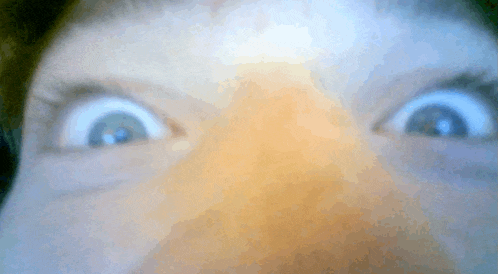 a close up of a person 's eyes making a surprised face
