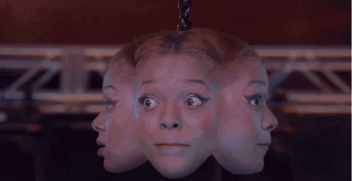 a woman 's head is hanging from a rope with three faces on it .