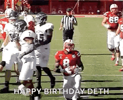 a group of football players on a field with the words `` happy birthday deth '' written in the corner .