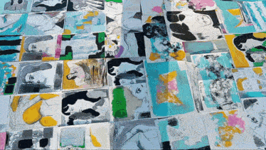 a bunch of paintings on a table including one that says ' i love you '