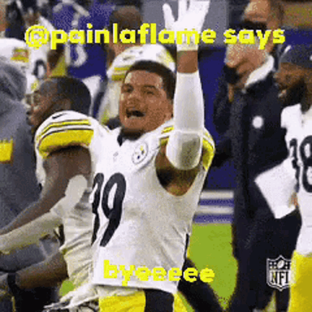 a football player with the number 19 on his jersey is raising his hands in the air .